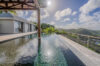 Infinity pool at a St Barts villa rental overlooking lush green hills and Caribbean sky