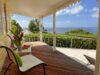 Ocean-view terrace at St Barts villa with tropical flowers and seating area