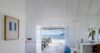 Bright beachfront living space with open doors leading to terrace and ocean view in St Barts villa rental