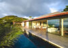 Contemporary St Barts villa with floor-to-ceiling glass, open living spaces, and poolside terrace overlooking the hills.