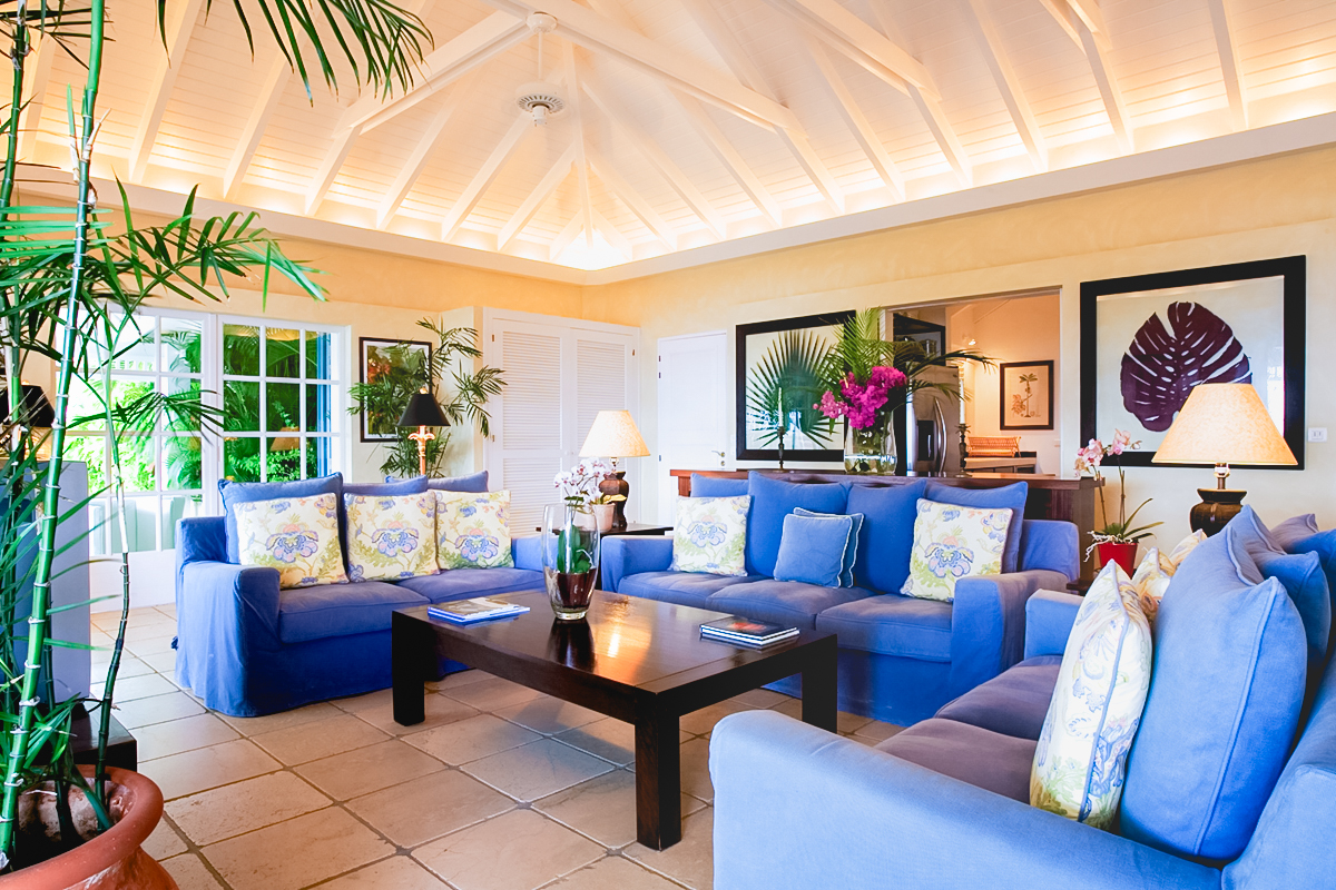 Colorful living room in St Barts villa rentals with vaulted ceiling and tropical decor