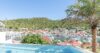 Infinity pool at St Barts villa overlooking Gustavia harbor with yachts and hillside views, vacation rental St Barths