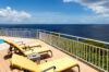 Sun deck of St Barts villa rentals with yellow loungers and Caribbean Sea views