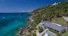 Clifftop St Barts villa with private pool overlooking turquoise Caribbean waters and hillside dotted with yachts.