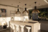 Modern kitchen with island seating and pendant lights inside luxury villa St Barths rental
