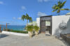 Clifftop St Barts villa pool with panoramic ocean views and sun loungers under Caribbean skies.