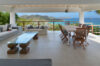 Poolside terrace with cushioned wooden loungers facing a private villa in a St Barts vacation rental.