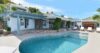 Private villa with mosaic-tiled pool, sun loungers, and shaded pergola terrace in a St Barts vacation rental.