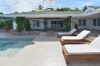 Villa exterior with mosaic-tiled pool, shaded pergola, and sun loungers in a private St Barts vacation rental.
