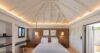 Elegant bedroom in private villa rentals St Barts with vaulted ceiling and soft lighting.
