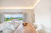 Bright bedroom in a St Barts villa rental with terrace view of tropical gardens and ocean horizon