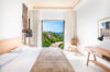 Bright bedroom in a St Barts villa rental with terrace view of tropical gardens and ocean horizon.