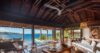 Open-air villa living room with wooden ceiling, stylish seating, and panoramic ocean views in St Barts vacation rental. Would you like m