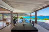 Covered outdoor dining area with sea view and pool in a St Barts villa rental