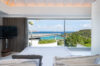 Bedroom with panoramic floor-to-ceiling windows overlooking Caribbean Sea in luxury St Barts villa rental.