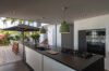 Sleek modern kitchen with outdoor dining terrace and garden views in St Barts villa rental.