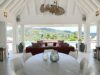 Open pavilion with round dining table and lounge area at luxury villa rental in St Barts