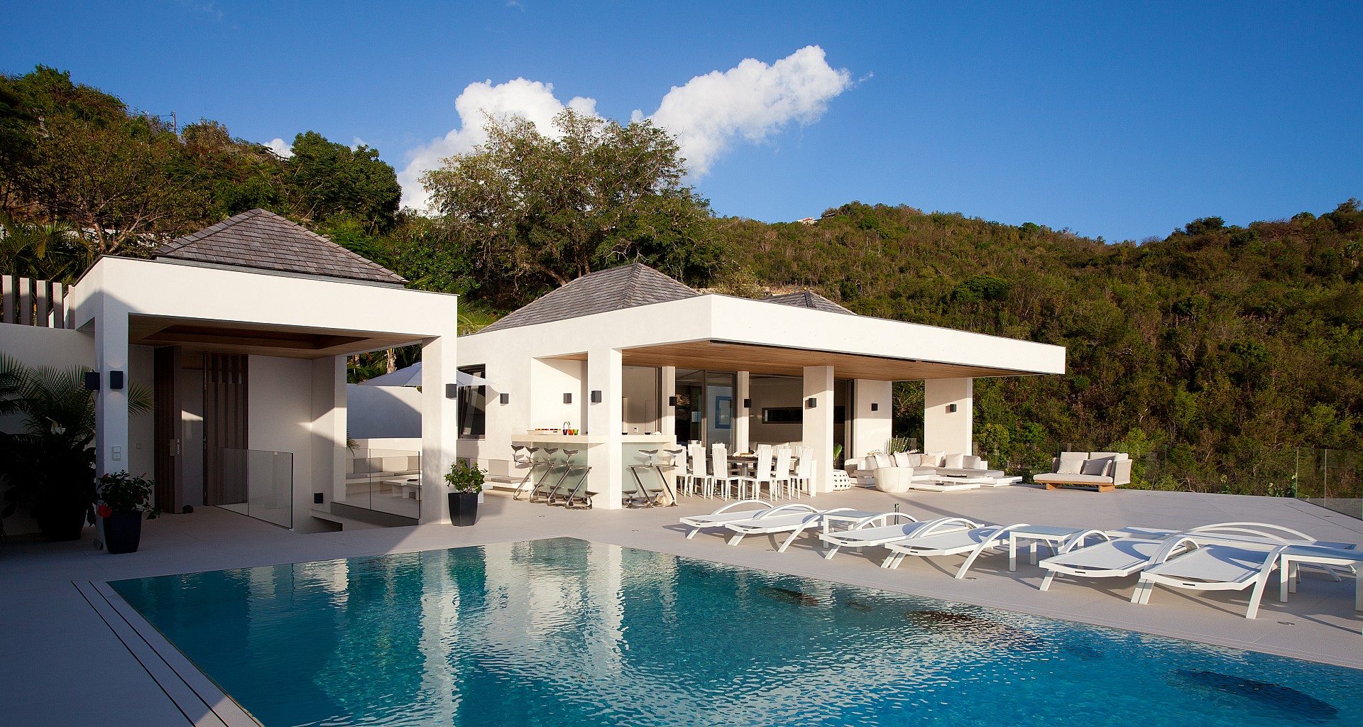 Contemporary St Barts villa with poolside loungers and hillside views