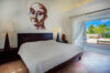 Bedroom with contemporary artwork, terrace access, and garden view at St Barthelemy vacation rental