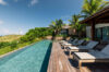 Poolside lounge area with comfortable seating overlooking a stunning natural view