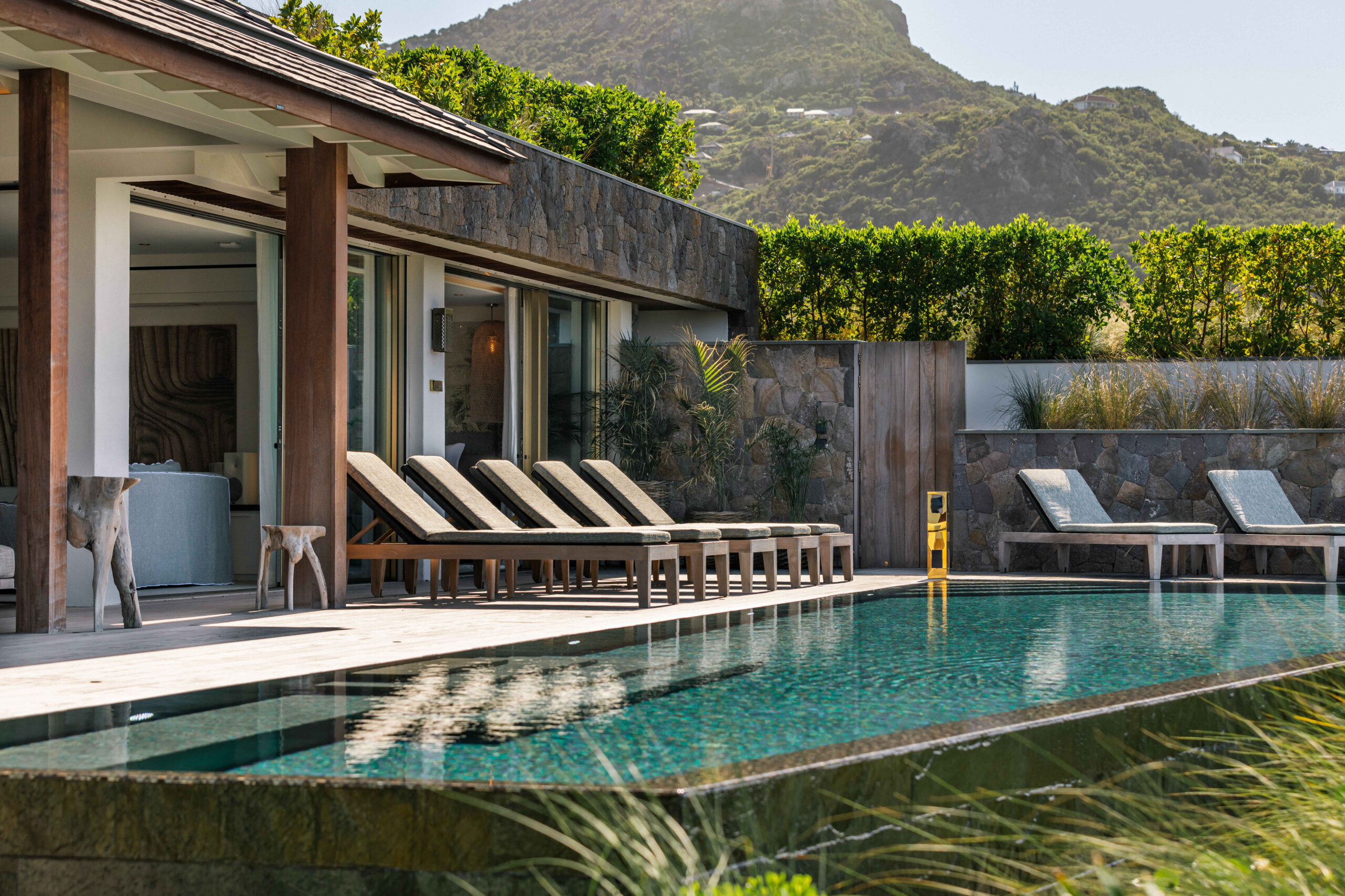 Cozy pool lounge area with a breathtaking view of nature or ocean.