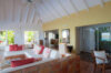 Bright living room with vaulted ceiling, terracotta details, and tropical accents inside a hillside St Barts villa rental.