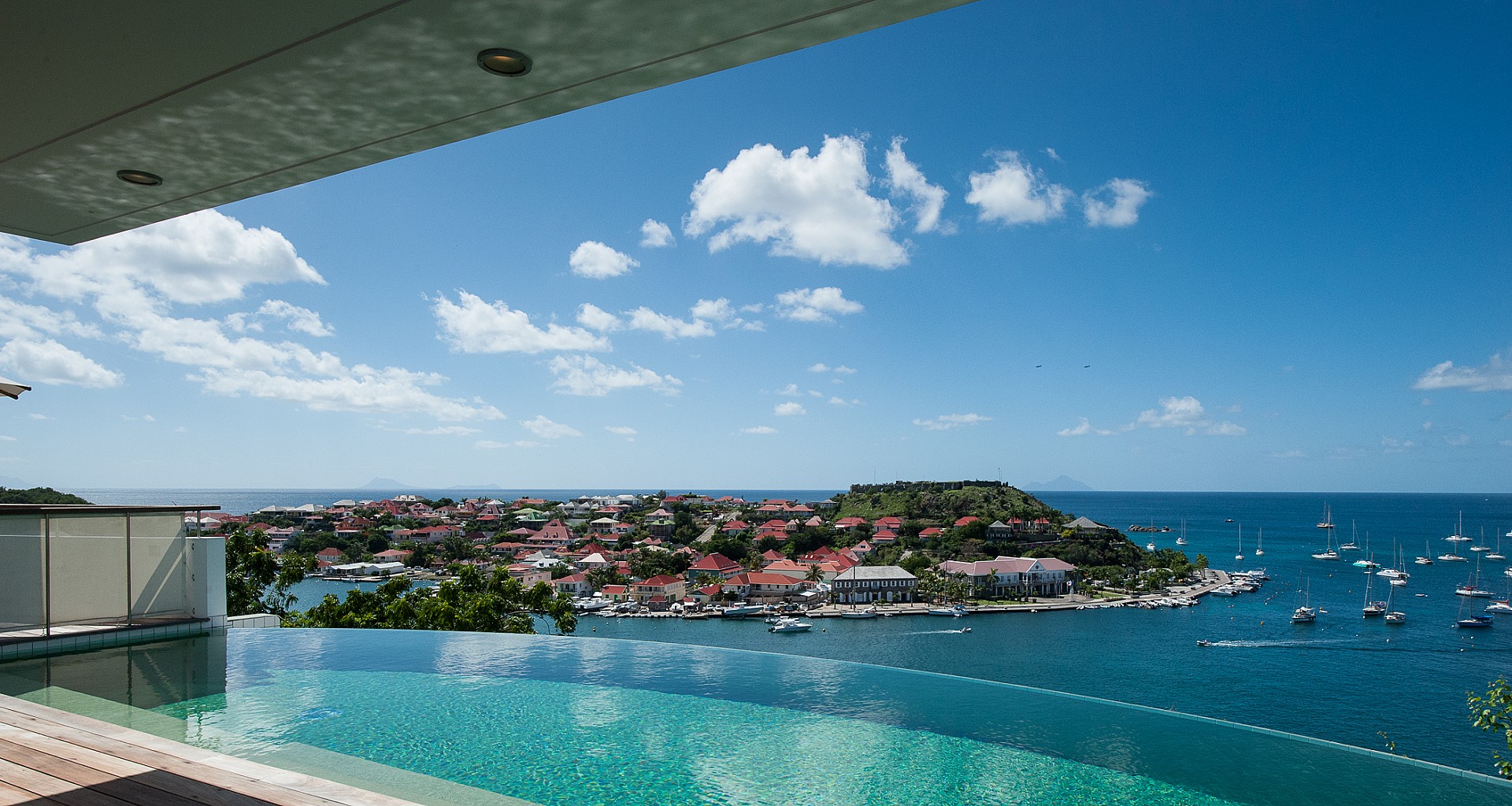 Stunning scene showcasing an infinity pool that blends seamlessly into the surrounding lush nature, creating a tranquil and picturesque view