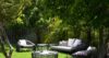 Shaded garden lounge at a St Barts villa with wicker seating, soft cushions, and lush greenery creating a tranquil retreat.