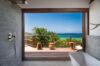 Luxury villa bathroom in St Barts with ocean-view bathtub and private terrace.