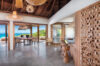 Open-plan villa dining and kitchen space in St Barts with sea views and natural wood accents.