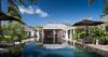 Luxury St Barts villa with tropical gardens and a long infinity pool under blue skies