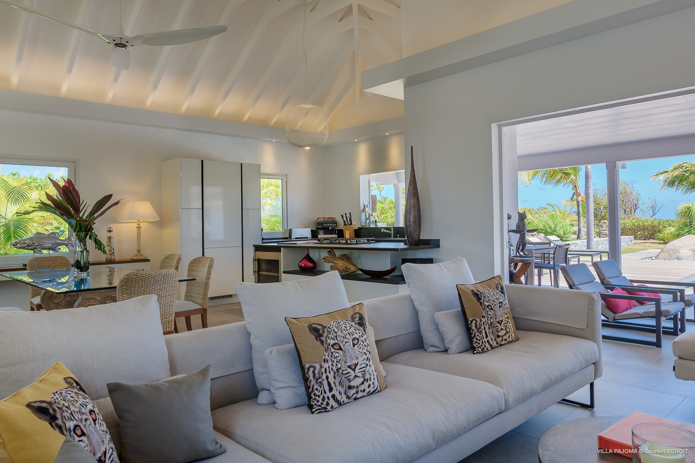Open-plan living room with modern sofa and terrace access at St Barts vacation rental