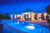 Villa illuminated at night with glowing pool and open-air terrace in a luxury St Barts vacation rental.