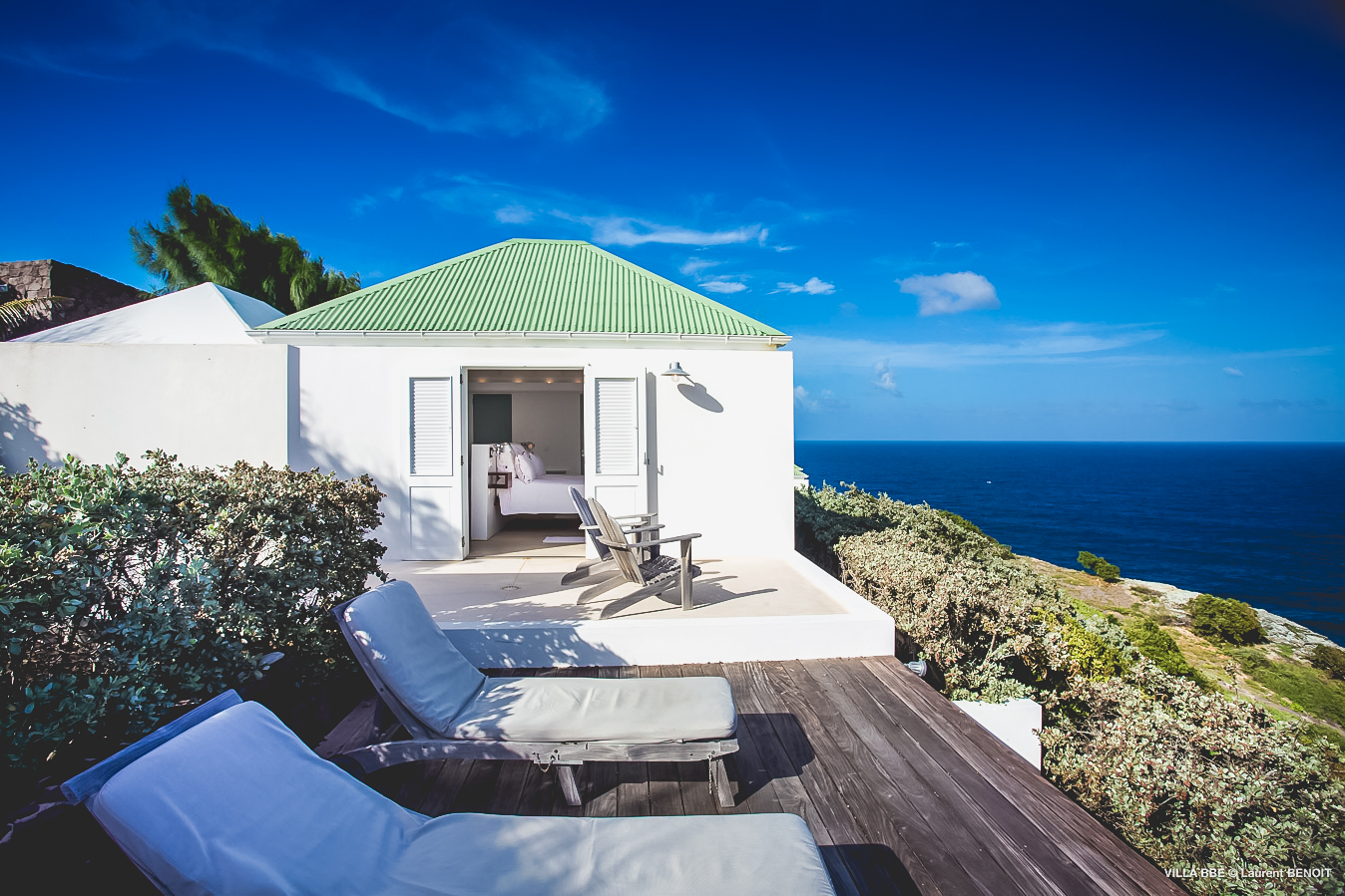 Sun terrace with lounge chairs and ocean view at luxury villa in St Barts