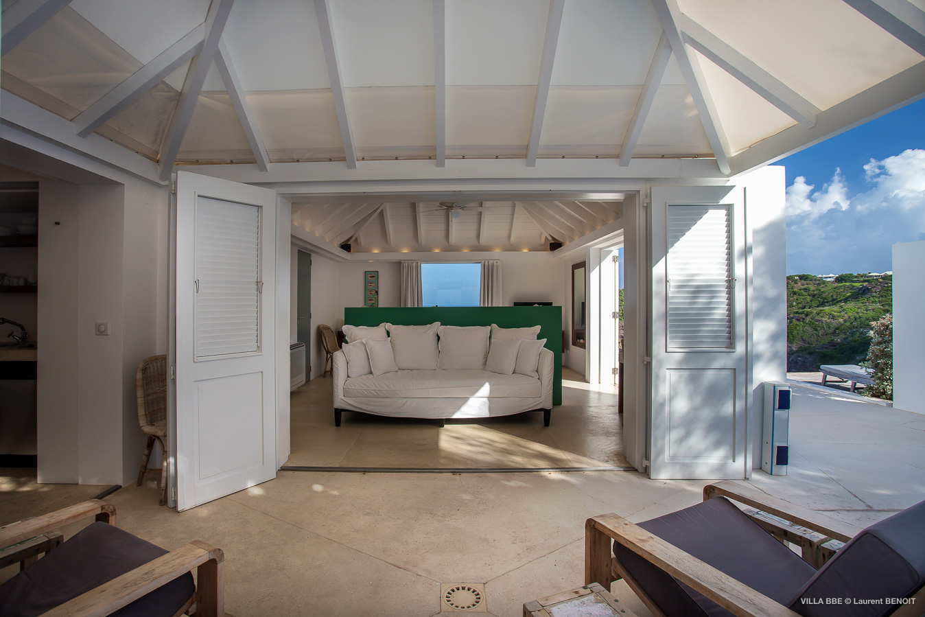 Open-air bedroom with canopy ceiling and ocean view in luxury St Barths villa rental.