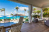 Covered terrace with dining and lounge area facing the ocean at a luxury St Barts villa