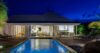 Evening view of illuminated pool and terrace at contemporary St Barts villa rental