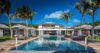 Luxury St Barts villa with expansive swimming pool, palm trees and elegant Caribbean architecture