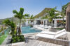 Modern terrace with sun loungers, infinity pool, and mountain views at a luxury villa in St Barts