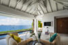 Open-plan living room with colorful seating and panoramic sea view at luxury villa in St Barts