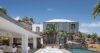 Contemporary St Barts villa with poolside loungers, stone accents, and modern architecture