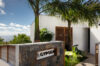 Entrance of Villa Gypsea in St Barts framed by palm trees and tropical greenery