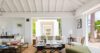 Airy living room in a St Barts villa with open design, neutral décor and views through wide terrace doors