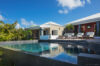 Contemporary infinity pool beside sun terrace at private villa rentals in St Barts