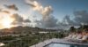 Pool terrace with sun loungers and sunset hillside view at private villa rental in St Barts