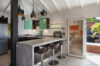 Modern kitchen in St Barts villa rental with breakfast bar, pendant lights, and terrace access.