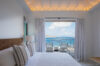 Serene bedroom in St Barts villa with ocean-facing terrace and contemporary coastal design
