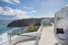 Clifftop terrace in St Barts villa with hanging chair and panoramic ocean views
