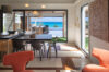 Modern indoor dining area with ocean view terrace at a luxury villa rental in St Barts
