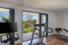 Private villa gym with treadmill, bike, and garden views at a luxury St Barts rental